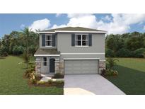 Two-story home featuring stone accents, gray siding, shutters, landscaped yard, and a two-car garage at 10484 Tucker Rd, Weeki Wachee, FL 34613