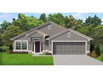 Charming single-story home featuring a neutral color scheme, a symmetrical facade, and an attached two-car garage at 5469 Ocean Breeze Dr, Spring Hill, FL 34609