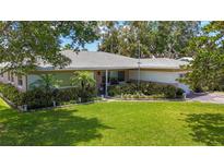 Charming single-story home with a lush green lawn, mature trees, and well-maintained landscaping at 1137 Indian Rocks S Rd, Largo, FL 33770