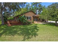Charming bungalow with a lush lawn and inviting deck, perfect for relaxing outdoors at 39 Sunset Dr, Brooksville, FL 34601