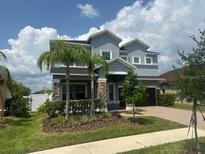 Charming two-story home with a landscaped yard, beautiful stone accents, and a two-car garage at 11928 Frost Aster Dr, Riverview, FL 33579