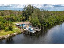 Aerial view showing waterfront home with boat dock at 1422 Bayshore Rd, Ruskin, FL 33570