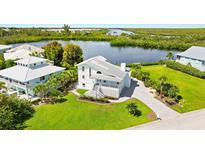 Waterfront property with lush landscaping and canal view at 13065 Via Aurelia, Placida, FL 33946