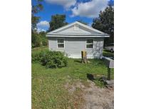 Single-story home with grey siding and a spacious yard at 702 Hillsboro St, Plant City, FL 33563