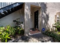 Exterior view of condo building showcasing landscaping and entrance at 4837 Puritan Cir # 2505, Tampa, FL 33617