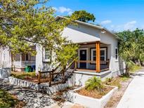Charming stucco home with a cozy front porch and well-maintained landscaping at 2335 W Beach St, Tampa, FL 33607