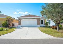 House exterior featuring a two-car garage and stone accents at 3051 27 E Ct, Palmetto, FL 34221