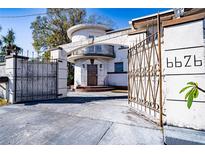 White stucco home with circular drive and gated entry at 6626 1St N St, St Petersburg, FL 33702