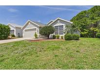 Charming single-story home with well-manicured lawn and lush landscaping at 10169 Holly Berry Dr, Weeki Wachee, FL 34613