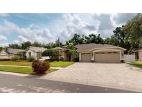 Beautiful single-story home featuring a paver driveway and a well-manicured lawn at 4506 Gentrice Dr, Valrico, FL 33596