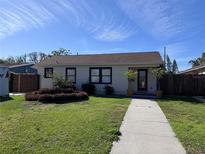 Charming single-story home features a well-maintained front lawn, complemented by neatly trimmed hedges and inviting walkway at 836 41St N Ave, St Petersburg, FL 33703