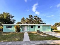 Charming single-story home with a well-manicured lawn and a convenient attached garage at 21077 Gertrude Ave, Port Charlotte, FL 33952