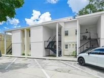 Two-story condominium building with parking in front and stairs leading to upper units at 3811 N Oak Dr # E62, Tampa, FL 33611
