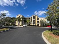Exterior view of a condominium building with covered parking at 7121 River Hammock Dr # 107, Bradenton, FL 34212