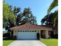 Single-story home with a two-car garage and Spanish tile roof at 1608 Bob O Link Dr, Venice, FL 34293