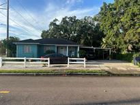 Quaint teal home with carport and white picket fence at 2415 E 21St Ave, Tampa, FL 33605