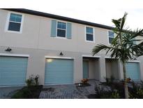 Modern townhouse with light blue garage doors at 5439 Tripoli Dr, Palmetto, FL 34221