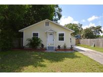 Charming yellow house with a well-manicured lawn and driveway at 2852 60Th N Ave, St Petersburg, FL 33714