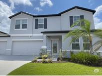 Charming two-story home with a well-maintained lawn and a two-car garage at 3522 N Maryland Ave, Plant City, FL 33565