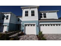 Two-story townhome with attached garage and well-manicured landscaping at 290 Via Anina Dr, Sarasota, FL 34243