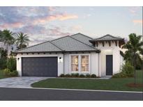 Charming single-story home featuring a two-car garage and tropical landscaping at 229 Vistera Blvd, North Venice, FL 34275