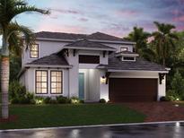 Charming two-story home featuring lush landscaping, a brick driveway and a two car garage at 17236 Savory Mist Cir, Bradenton, FL 34211