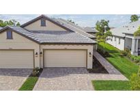 Charming townhome with a brick driveway and a two-car garage, plus well manicured lawn and landscaping at 17982 Cherished Loop, Bradenton, FL 34211