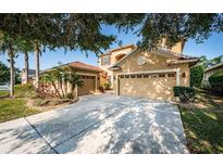 Charming home featuring lush landscaping and a two-car garage, plus a separate garage, offers great curb appeal at 3033 Stonegate Falls Dr, Land O Lakes, FL 34638