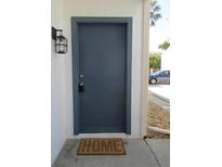 Inviting entryway features a painted front door, stylish lantern, and a 