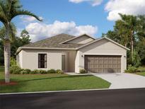 Beautiful single-story home featuring a two-car garage and a well-manicured lawn and landscaping at 9864 Last Light Gln, Parrish, FL 34219
