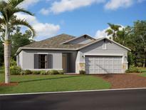 Charming single-story home features a well-kept lawn, beautiful landscaping, and an attached two-car garage at 9986 Last Light Gln, Parrish, FL 34219