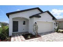 Charming single-Gathering home with a modern architectural style, featuring a well-manicured lawn and a two-car garage at 16833 Fiesta Dr, Port Charlotte, FL 33953