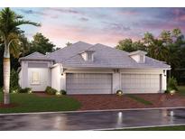 Elegant single-story home boasting a three-car garage, lush landscaping, and a beautifully paved driveway at 18060 Cherished Loop, Bradenton, FL 34211