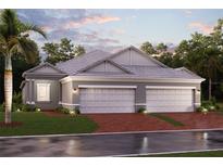 Charming single-story home featuring a three-car garage, well-manicured lawn, and tropical landscaping at 18064 Cherished Loop, Bradenton, FL 34211