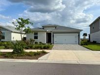 Charming single-Gathering home with a two-car garage, paver driveway and well-manicured landscaping at 43819 Cattleman Dr, Punta Gorda, FL 33982