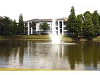 Community pond and fountain offer scenic views from this building with ample parking at 5613 Legacy Crescent Pl # 201, Riverview, FL 33578