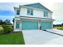Charming two-story home with attached two-car garage, stone accents and a well-manicured lawn at 13622 Wolfpack Rd, Hudson, FL 34667