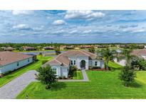 Stunning single-story home with tile roof, lush landscaping, and picturesque lake view at 16617 5Th E Ave, Bradenton, FL 34212