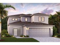 Two-story home featuring a modern design, a neutral color palette, an attached two-car garage, and manicured landscaping at 16836 Fiesta Dr, Port Charlotte, FL 33953