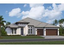 A charming single-story home featuring a light exterior, two-car garage, and meticulously manicured landscaping at 18534 Foxtail Loop, Venice, FL 34293