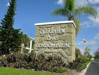 Stone sign for Clearview Oaks Condominium with lush landscaping and blue sky at 4154 57Th N St # 272, Kenneth City, FL 33709