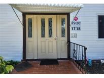 Apartment entrance featuring triple doors, brick entryway, awning, and address numbers at 22481 Westchester Blvd # A19, Punta Gorda, FL 33980