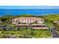 Waterfront condo building with covered parking and lush landscaping at 2725 Terra Ceia Bay Blvd # 201, Palmetto, FL 34221