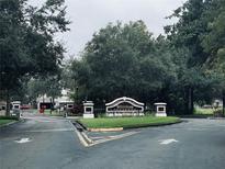 Westpark community entrance featuring sign, mature trees, and wrought iron gate at 10453 Westpark Preserve Blvd, Tampa, FL 33625