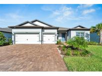 Two-story home with two-car garage and landscaping at 5735 Shorebird Br, Land O Lakes, FL 34638