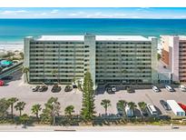 Aerial view of beachfront building with parking lot at 20000 Gulf Blvd # 707, Indian Shores, FL 33785