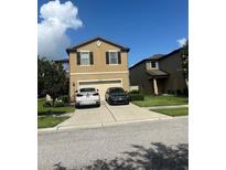 Two-story house with a two-car garage and well-maintained lawn at 6327 Yellow Buckeye Dr # 6327, Riverview, FL 33578