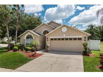 Charming single Gathering home featuring manicured landscaping and an attached two-car garage at 7139 Colony Pointe Dr, Riverview, FL 33578