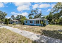 Quaint one-story blue house with a well-lit sunroom and sidewalk to street at 1724 Harbor Dr, Clearwater, FL 33755