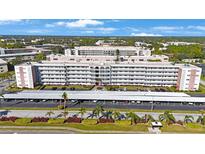 Spacious condominium featuring lush landscaping, assigned covered parking and desirable curb appeal at 5501 80Th N St # 201, St Petersburg, FL 33709